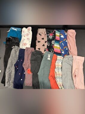 Bundle of 18 toddler pants and leggings, sized between 6 and 12 months.